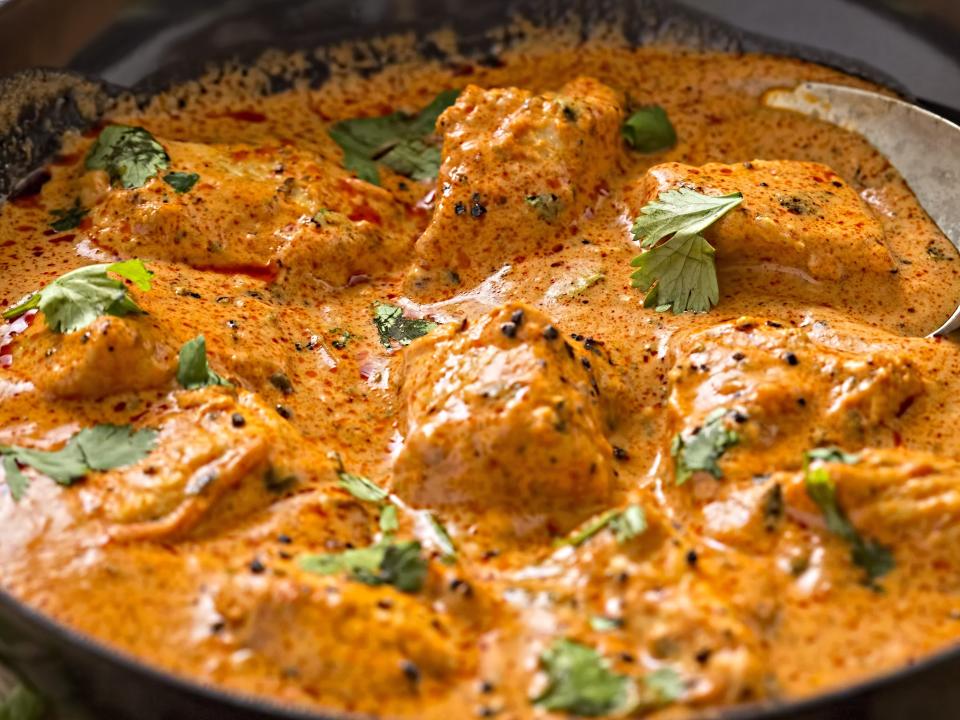 butter chicken in a cast iron pan