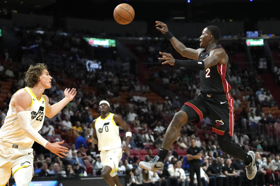 Miami Heat guard Terry Rozier (2) passes the ball to Jimmy Butler, not shown, as Utah Jazz forward Lauri Markkanen (23) defends during the first half of an NBA basketball game, Saturday, March 2, 2024, in Miami. (AP Photo/Lynne Sladky)