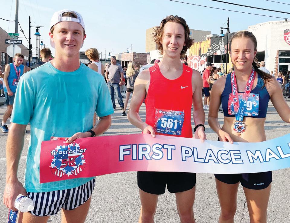 Bartlesville High grad Henry Williams, center, stormed to first place in July 2021 in a prestigious Tulsa run that featured approximately 1,500 runners. Helping him celebrate are his borther Max — who finished fifth overall — and sister Liza.