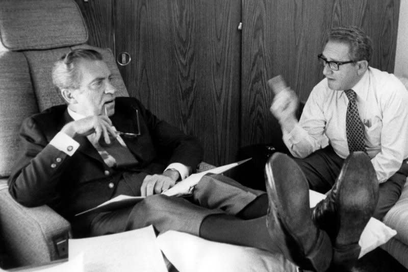 President Richard Nixon (L) and Secretary of State Henry Kissinger confer aboard Air Force One as they head toward Brussels, Belgium in 1974 for NATO talks. UPI File Photo