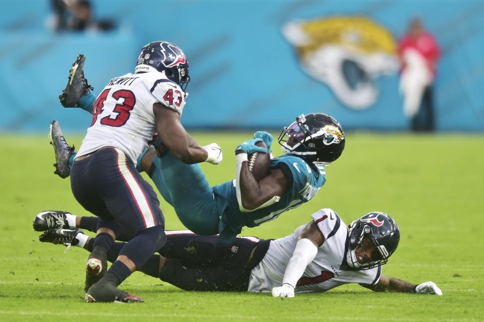 Houston safety Lonnie Johnson (1) tackles Jaguars receiver Laquon Treadwell (18) during the third quarter on Sunday.