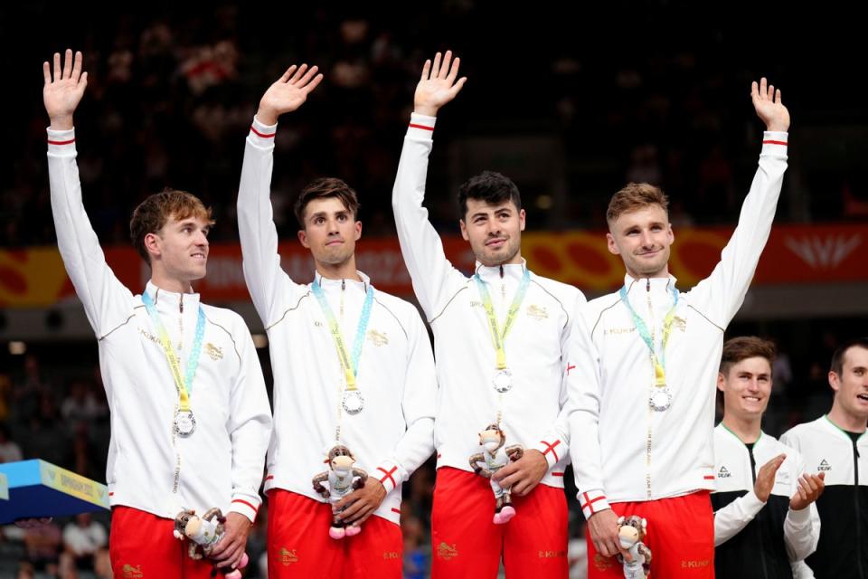 Dan Bigham, right, celebrates England’s men’s team pursuit silver with Ethan Vernon, Ollie Wood and Charlie Tanfield (John Walton/PA) (PA Wire)