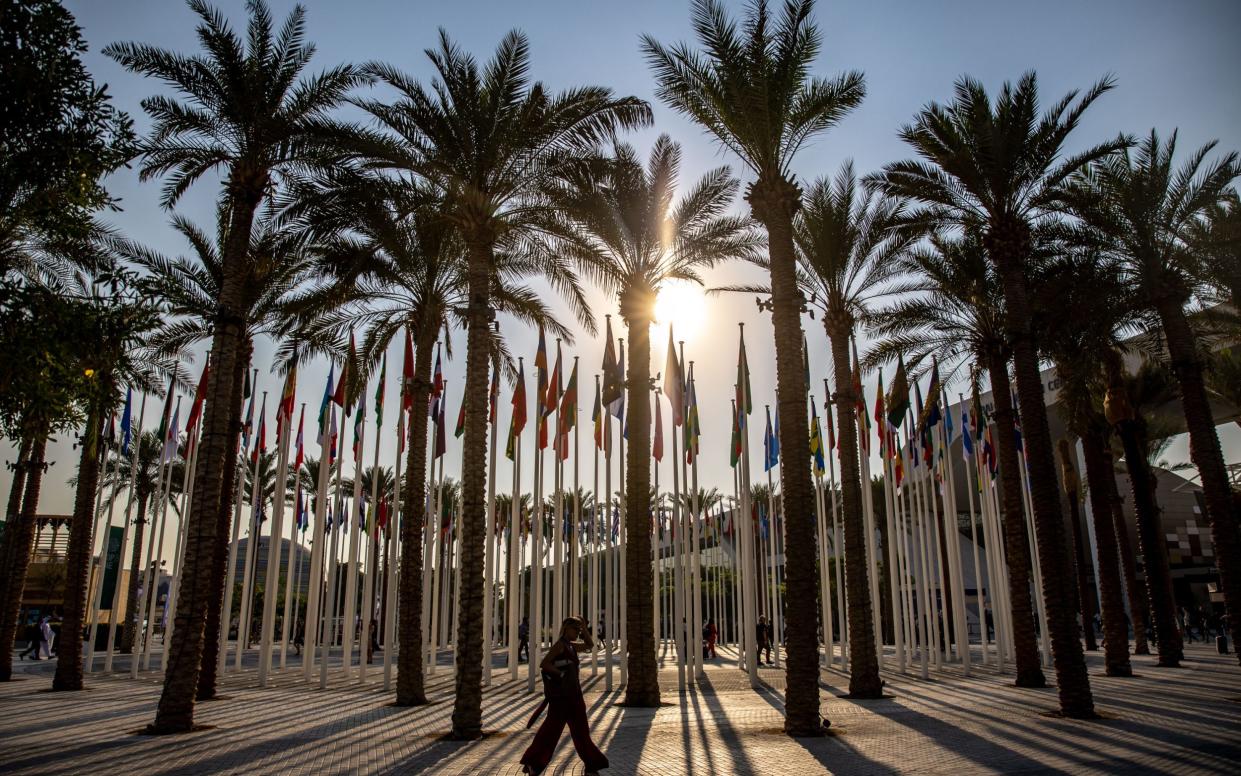 A participant walks at Expo City Dubai, the venue of the 2023 United Nations Climate Change Conference (COP28), in Dubai, United Arab Emirates