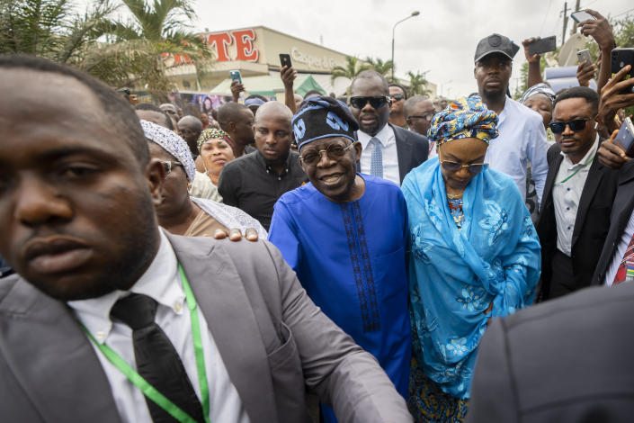 FILE - Presidential candidate Bola Tinubu, center, of the All Progressives Congress, accompanied by his wife Oluremi Tinubu, center right, arrives to cast his vote in the presidential elections in Lagos, Nigeria, Feb. 25, 2023. Election officials declared ruling party candidate Bola Tinubu the winner of Nigeria's presidential election early Wednesday, March 1, 2023, with the two leading opposition candidates already demanding a revote in Africa's most populous nation. (AP Photo/Ben Curtis, File)