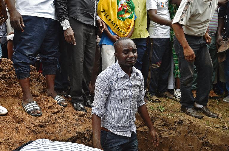 A Muslims man grieves as the body of Zedi Feruzi, the head of the Union for Peace and Development opposition party, is laid to rest in Bujumbura on May 24, 2015