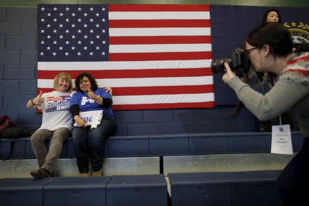 Karen Rouse (L) and Maria Perez pose for a photograph after listening to former U.S. President Bill Clinton campaign for his wife, U.S. Democratic presidential candidate Hillary Clinton, in Nashua, New Hampshire January 4, 2016. Both are volunteers for Hillary Clinton's campaign and Rouse volunteered for Bill Clinton's campaigns in 1992 and 1996. REUTERS/Brian Snyder