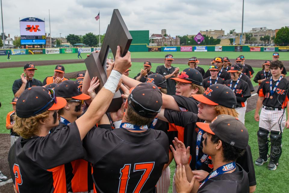 The Washington Panthers gather around their Class 3A state baseball third-place trophy after defeating Crystal Lake South 2-1 on Saturday, June 11, 2022 at Duly Health & Care Field in Joliet.