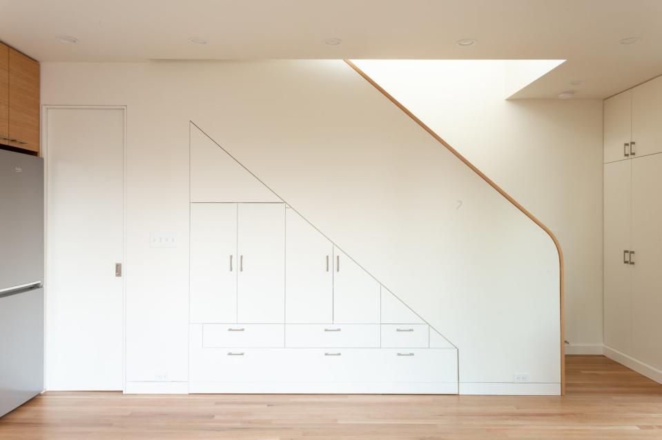 Built-in cabinetry beneath the staircase provides extra storage space for the 1,024-square-foot home.