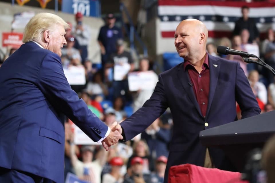 Pennsylvania Republican gubernatorial candidate Doug Mastriano is greeted by former president Donald Trump, who has backed the Republican state senator in the race, at a rally on 3 September 2022 (Getty Images)