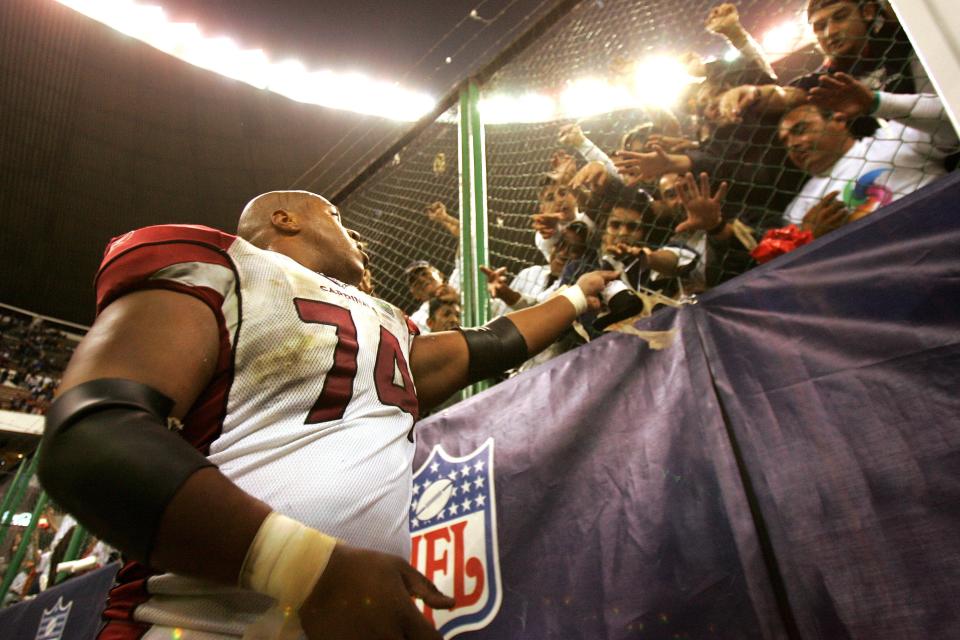 MEXICO CITY - OCTOBER 2:  Reggie Wells #74 of the Arizona Cardinals gives his gloves to fans after the game against the Arizona Cardinals at Estadio Azteca in Mexico City, Mexico.  The Cardinals won 31-14.  (Photo by Robert Laberge/Getty Images)