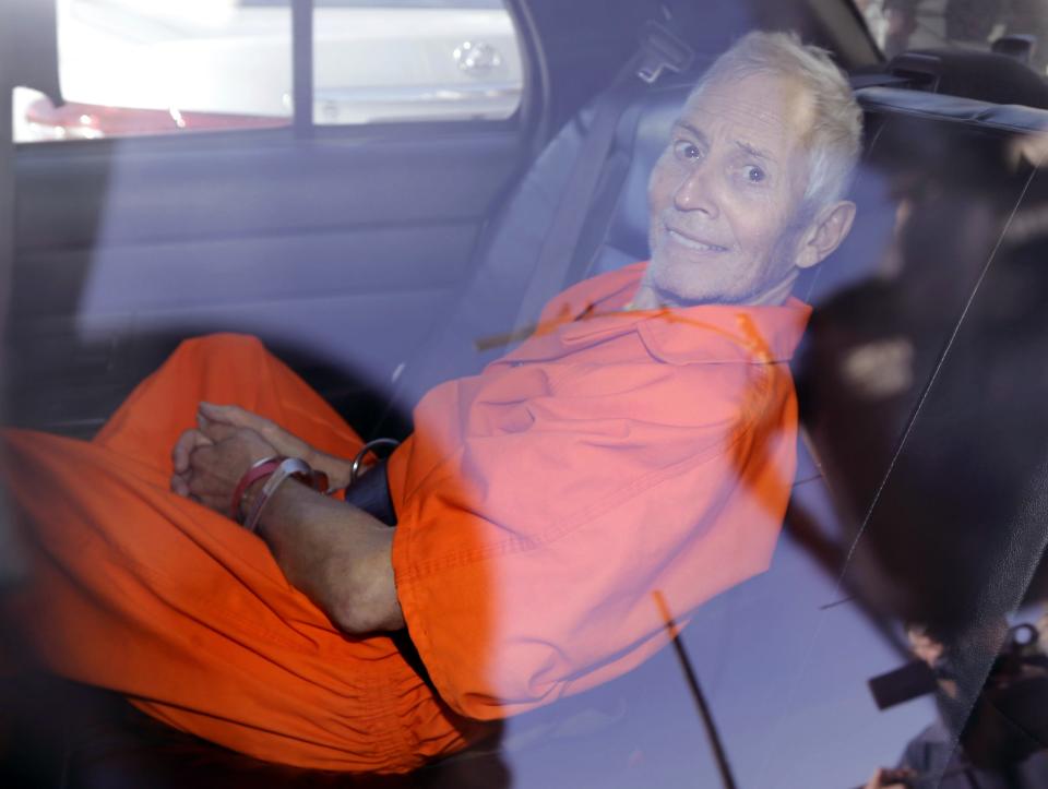 Robert Durst is transported from Orleans Parish Criminal District Court to the Orleans Parish Prison after his arraignment in New Orleans, Tuesday, March 17, 2015.  Durst was rebooked on charges of being a convicted felon in possession of a firearm, and possession of a weapon with a controlled dangerous substance, a small amount of marijuana. (AP Photo/Gerald Herbert)