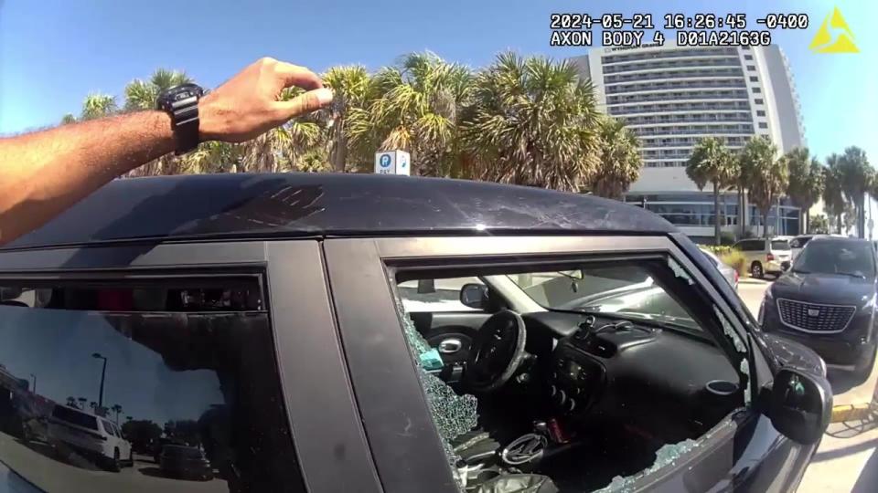<div>Clearwater police smashed a car's window in a beach parking lot to rescue a pitbull that was left inside. Courtesy of the Clearwater Police Department.</div>