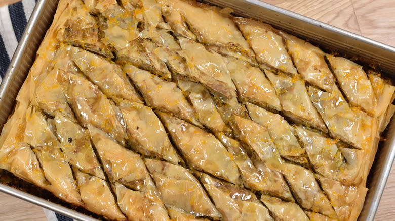 baklava with syrup on top in baking dish
