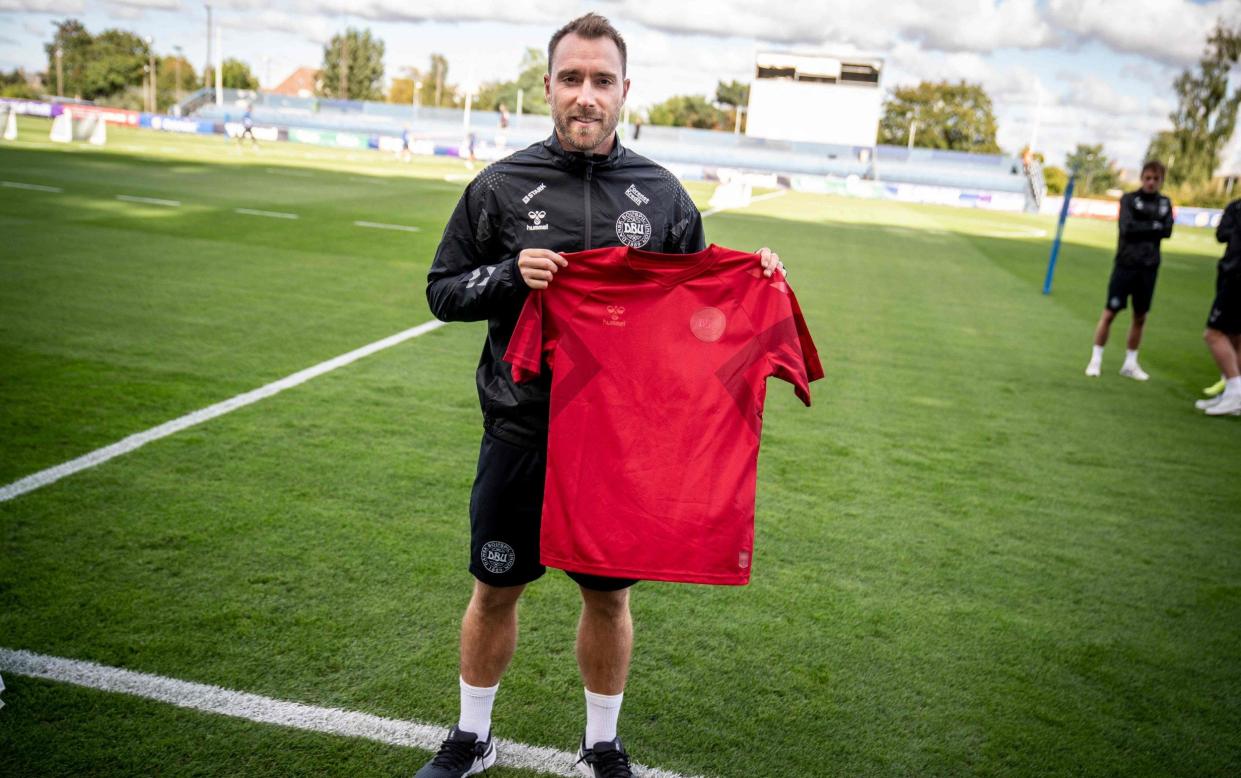  This picture taken on September 19, 2022 in Helsingborg, Denmark, shows Christian Eriksen, player of Denmark's national football team, wearing a black jersey and presenting the team's new red home jersey ahead of the upcoming FIFA 2022 Football World Cup. / Denmark World Cup 2022 squad list, fixtures and latest odds