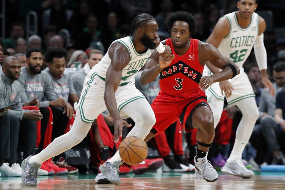 Boston Celtics' Jaylen Brown (7) drives past Toronto Raptors' O.G. Anunoby (3) during the first half of an NBA basketball game, Saturday, Nov. 11, 2023, in Boston. (AP Photo/Michael Dwyer)