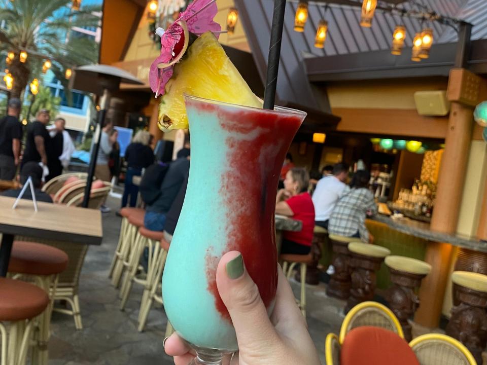 hand holding up a frozen cocktail at trader sams at disneyland