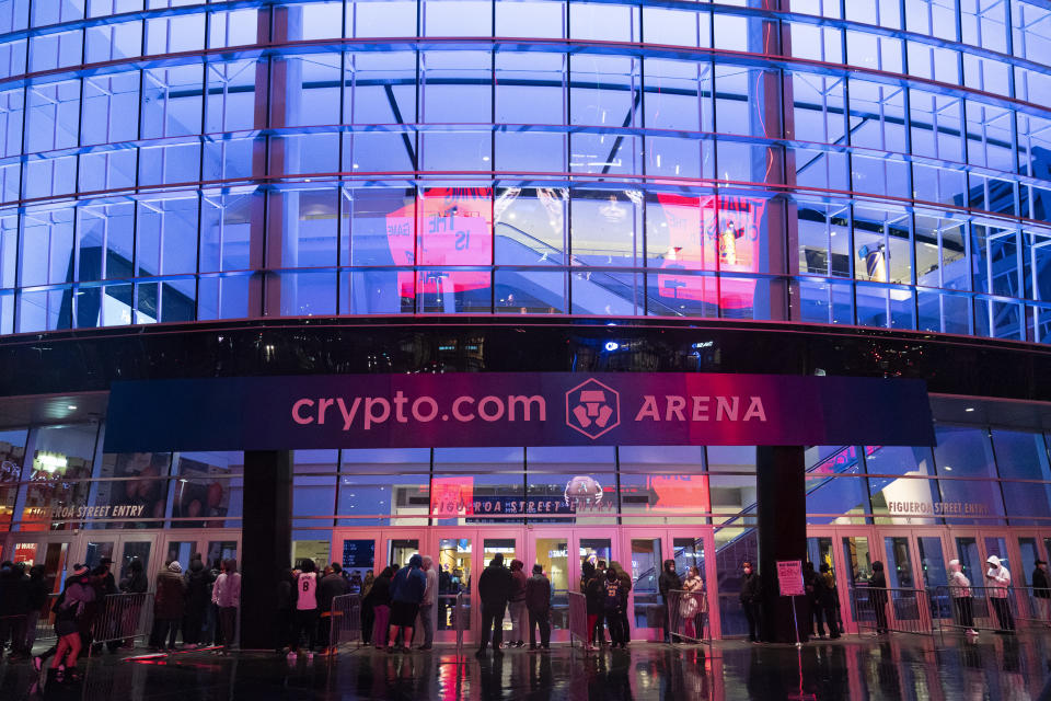 A Crypto.com Arena sign hangs outside Staples Center before an NBA basketball game between the Los Angeles Lakers and the San Antonio Spurs Thursday, Dec. 23, 2021, in Los Angeles. Staple Center will officially be renamed Crypto.com Arena on Christmas Day. (AP Photo/Jae C. Hong)