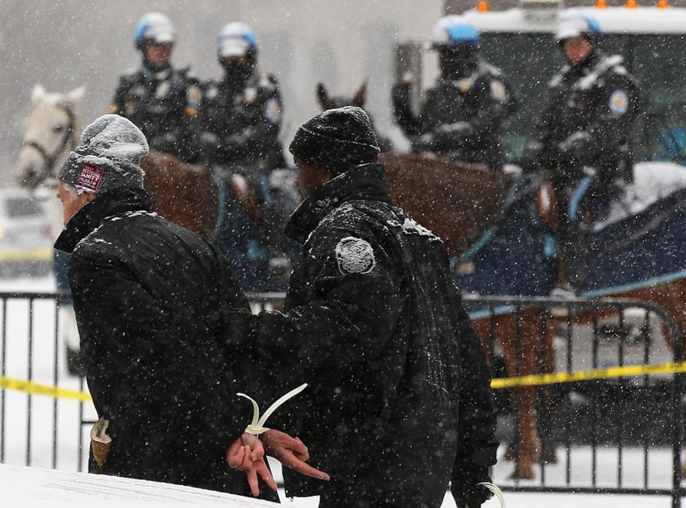 Daniel Ellsberg flashes two peace signs behind his back while being arrested during an anti-war protest in front of the White House in 2010. <a href="https://www.gettyimages.com/detail/news-photo/daniel-ellsberg-former-military-analyst-who-released-the-news-photo/107633304?adppopup=true" rel="nofollow noopener" target="_blank" data-ylk="slk:Win McNamee/Getty Images;elm:context_link;itc:0;sec:content-canvas" class="link ">Win McNamee/Getty Images</a>