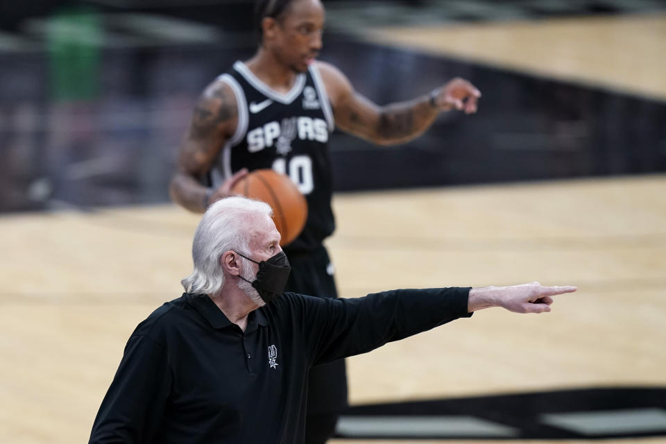 San Antonio Spurs coach Gregg Popovich directs players during the first half of an NBA basketball game against the New Orleans Pelicans in San Antonio, Saturday, Feb. 27, 2021. (AP Photo/Eric Gay)