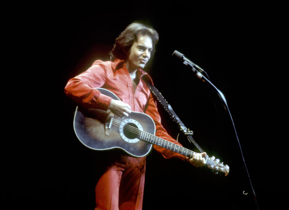 LOS ANGELES - CIRCA 1980: Singer Neil Diamond performs onstage wearing a red jumpsuit in circa 1980 in Los Angeles, California. (Photo by Michael Ochs Archives/Getty Images)