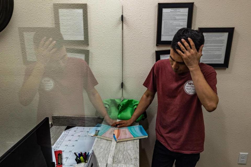 Mohammad Wasiq, a translator and Afghan refugee, tries to remember the English translation while speaking to the receptionist at Cornerstone Assistance Network in Fort Worth.