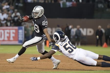 FILE PHOTO: September 10, 2018; Oakland, CA, USA; Oakland Raiders wide receiver Amari Cooper (89) runs against Los Angeles Rams linebacker Cory Littleton (58) during the first quarter at Oakland Coliseum. Mandatory Credit: Kyle Terada-USA TODAY Sports/File Photo