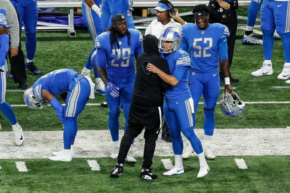 Eminem hugs quarterback Matthew Stafford before the Lions-Jets game at Ford Field in Detroit, Monday, Sept. 10, 2018.