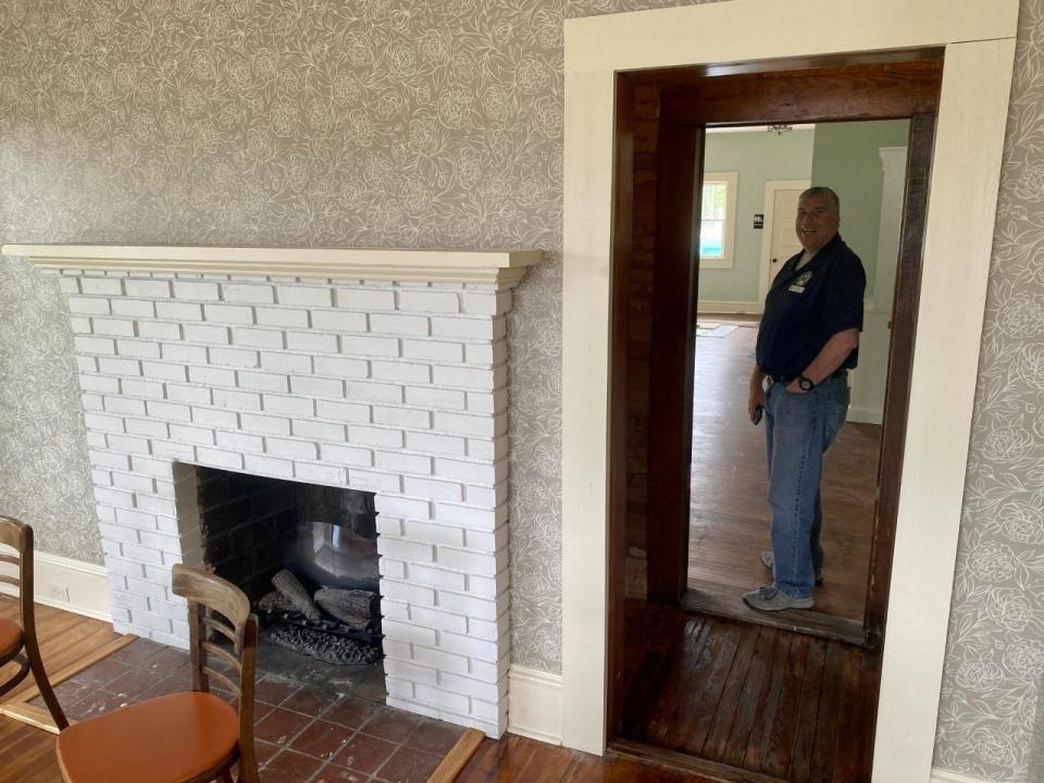 Crestview Cultural Services Specialist Brian Hughes stands next to a formerly walled-up "pass through" on the first floor of the historic Lorenza Bush House, which soon will serve as a city history museum.