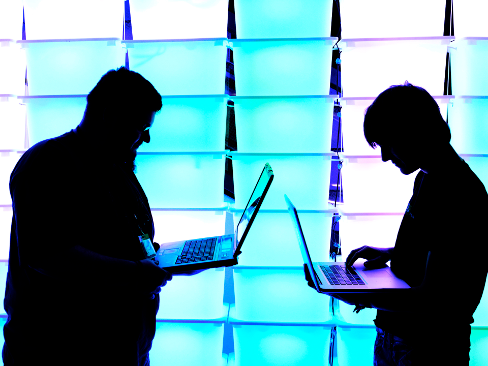 two men computers typing technology digital online internet