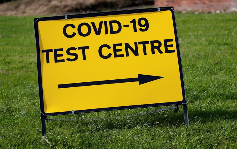 FILE PHOTO: A sign is seen outside a walk-in test facility following the outbreak of the coronavirus disease (COVID-19) in the Farnworth area of Bolton