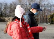 People wearing masks walk at the castle esplanade in Edinburgh, Scotland