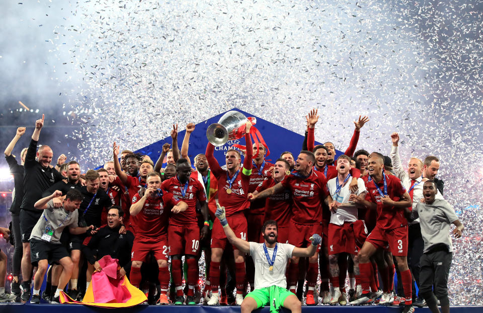 Liverpool players celebrate with the trophy after winning the UEFA Champions League Final at the Wanda Metropolitano, Madrid.