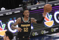 Memphis Grizzlies guard Ja Morant (12) passes during the first half of an NBA basketball game against the Washington Wizards, Tuesday, March 2, 2021, in Washington. (AP Photo/Nick Wass)