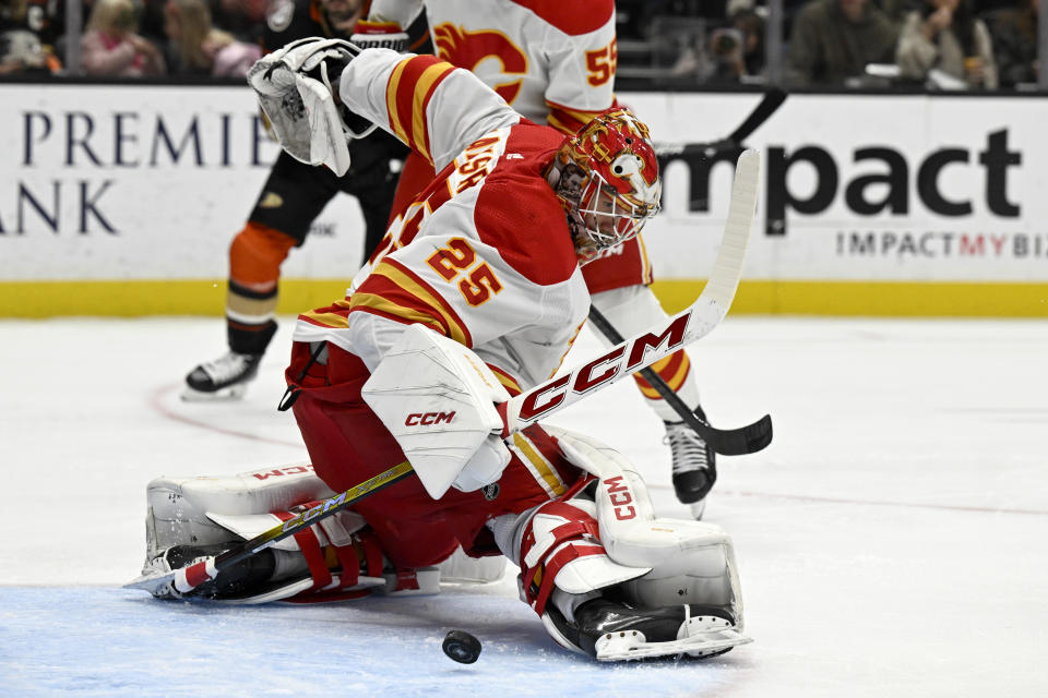 Calgary Flames goaltender Jacob Markstrom (25) deflects a shot by the Anaheim Ducks during the first period of an NHL hockey game in Anaheim, Calif., Thursday, Dec. 21, 2023. (AP Photo/Alex Gallardo)