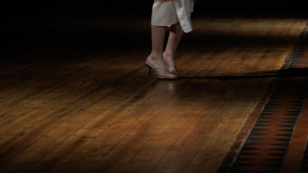 a person wearing a crown and standing on a stage