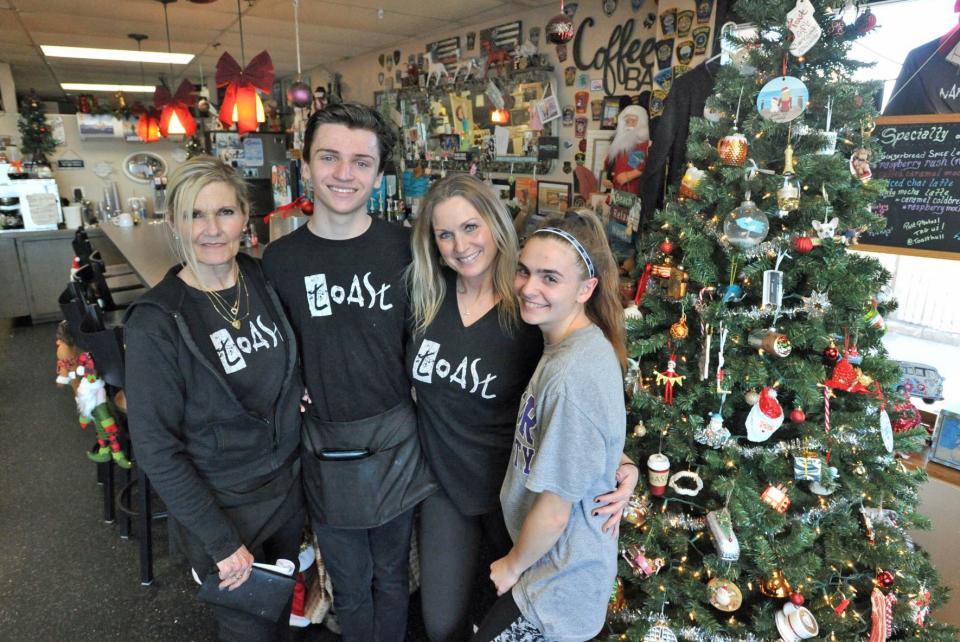 Jessica Travis, of Weymouth, second from right, owner of Toast restaurant in Hull, shown Thursday, Dec. 29, 2022, is joined by some of her staff members: from left, Maria Farley, of Scituate, Sean Lally, of Weymouth, and Stevie Ryan, of Hull. Travis is taking her entire 13-member staff and their families to Disney World in the spring as a surprise Christmas gift.