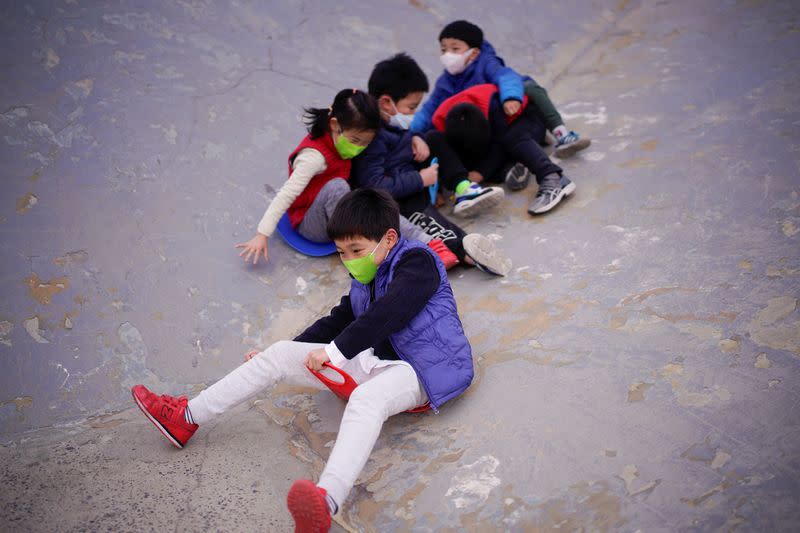 Children wearing face masks play at a park, as the country is hit by an outbreak of the novel coronavirus, in Shanghai