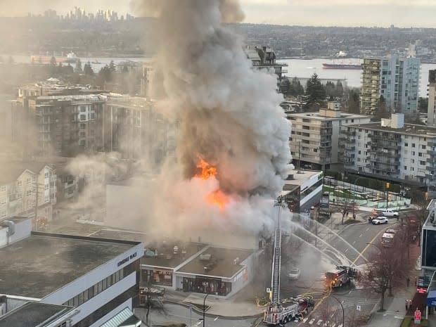 Flames engulf a building near Lonsdale Avenue and 12th Street in North Vancouver on Tuesday.