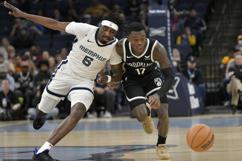 Memphis Grizzlies guard Vince Williams Jr. (5) and Brooklyn Nets guard Dennis Schroder (17) chase a loose ball in the first half of an NBA basketball game Monday, Feb. 26, 2024, in Memphis, Tenn. (AP Photo/Brandon Dill)