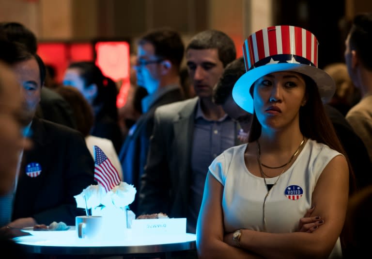 People react as they follow the results of the US presidential election at an event organised by the American consulate in Shanghai on November 9, 2016