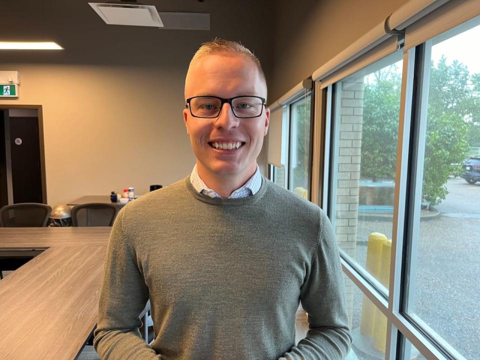 Cameron Choquette, the CEO of the Saskatchewan Landlord Association (SLA), stands in a boardroom at the SLA's office in Saskatoon.