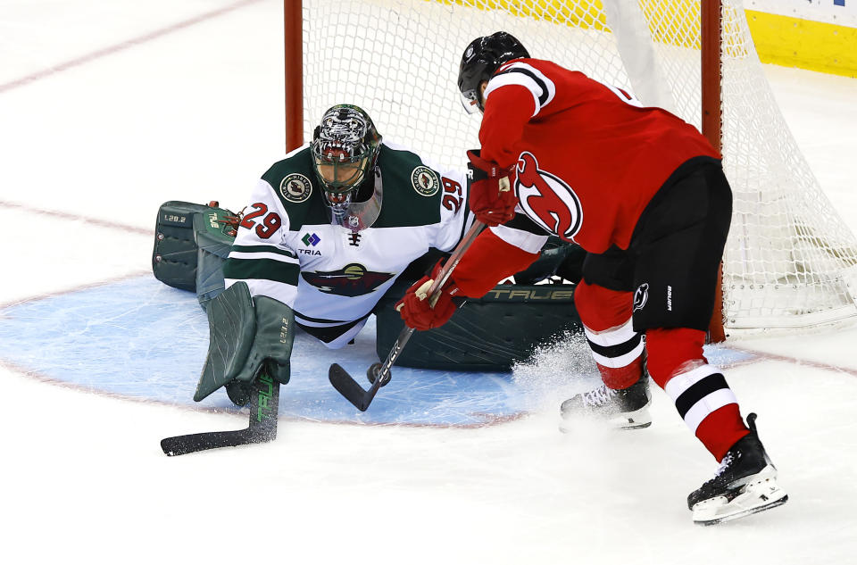 Minnesota Wild goaltender Marc-Andre Fleury (29) makes a save against New Jersey Devils center Curtis Lazar during the third period of an NHL hockey game, Sunday, Oct. 29, 2023, in Newark, N.J. (AP Photo/Noah K. Murray)