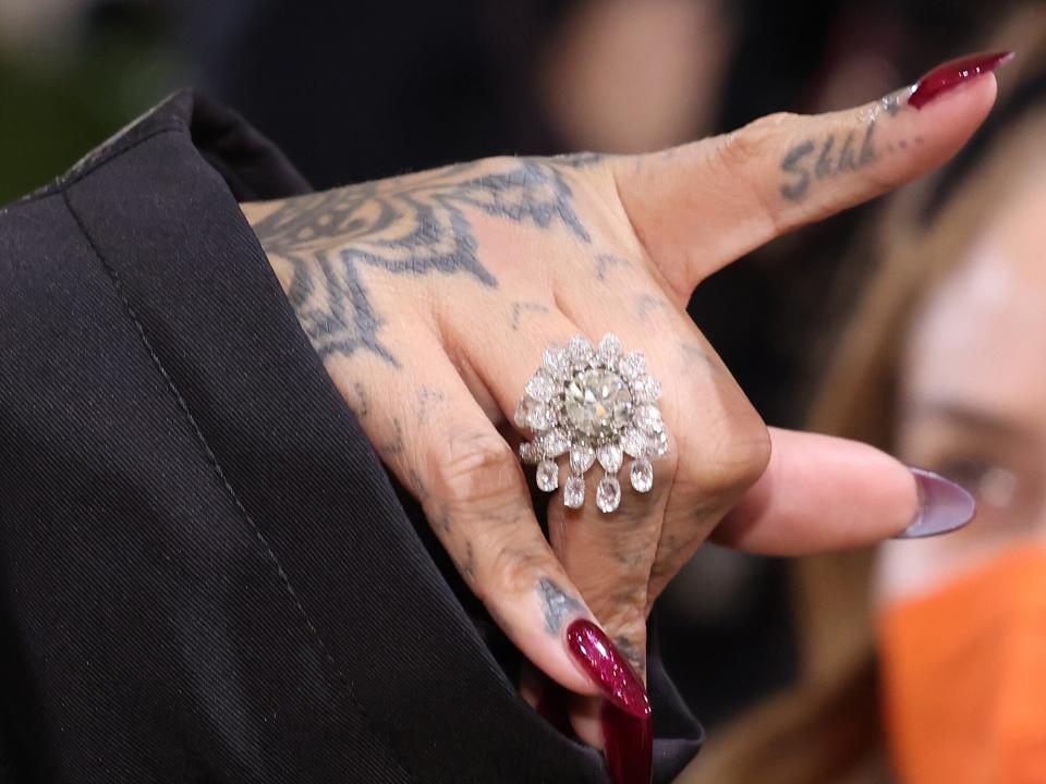 Rihanna, ring detail, tattoo detail, manicure detail, attends the 2021 Met Gala benefit "In America: A Lexicon of Fashion" at Metropolitan Museum of Art on September 13, 2021 in New York City