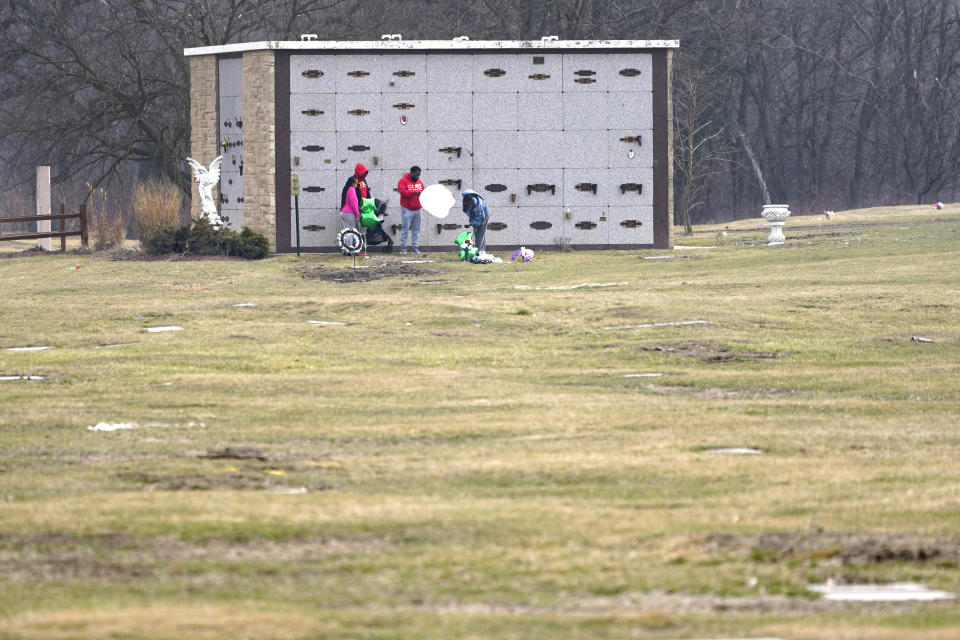 People place balloons and flowers near several burial vaults at the historic Mount Glenwood Cemetery Wednesday, March 17, 2021, in Glenwood, Ill. The cemetery was formed in 1908 by a group of Black businessmen with an explicit nondiscrimination clause in its charter. (AP Photo/Charles Rex Arbogast)