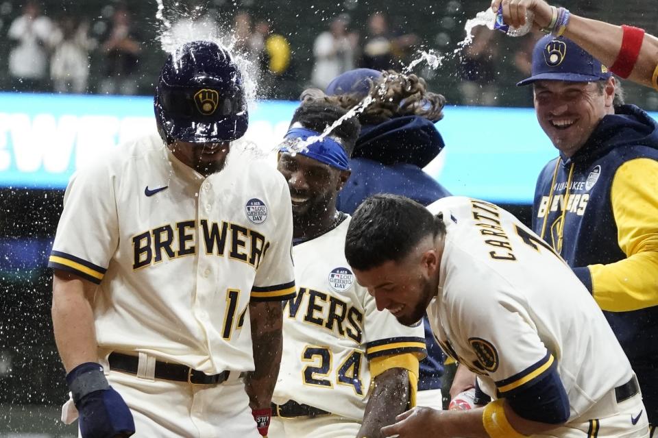 Milwaukee Brewers' Andrew McCutchen celebrates after hitting a walk-off RBI single during the ninth inning of a baseball game against the San Diego Padres Thursday, June 2, 2022, in Milwaukee. The Brewers won 5-4. (AP Photo/Morry Gash)