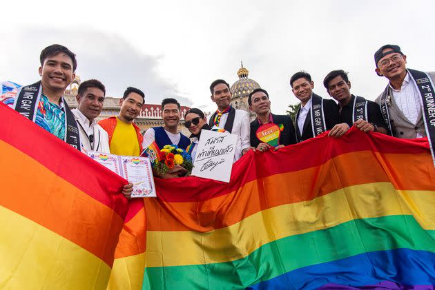 Participants hold a huge rainbow flag during the celebration event at the Government house in Bangkok, Thailand. 