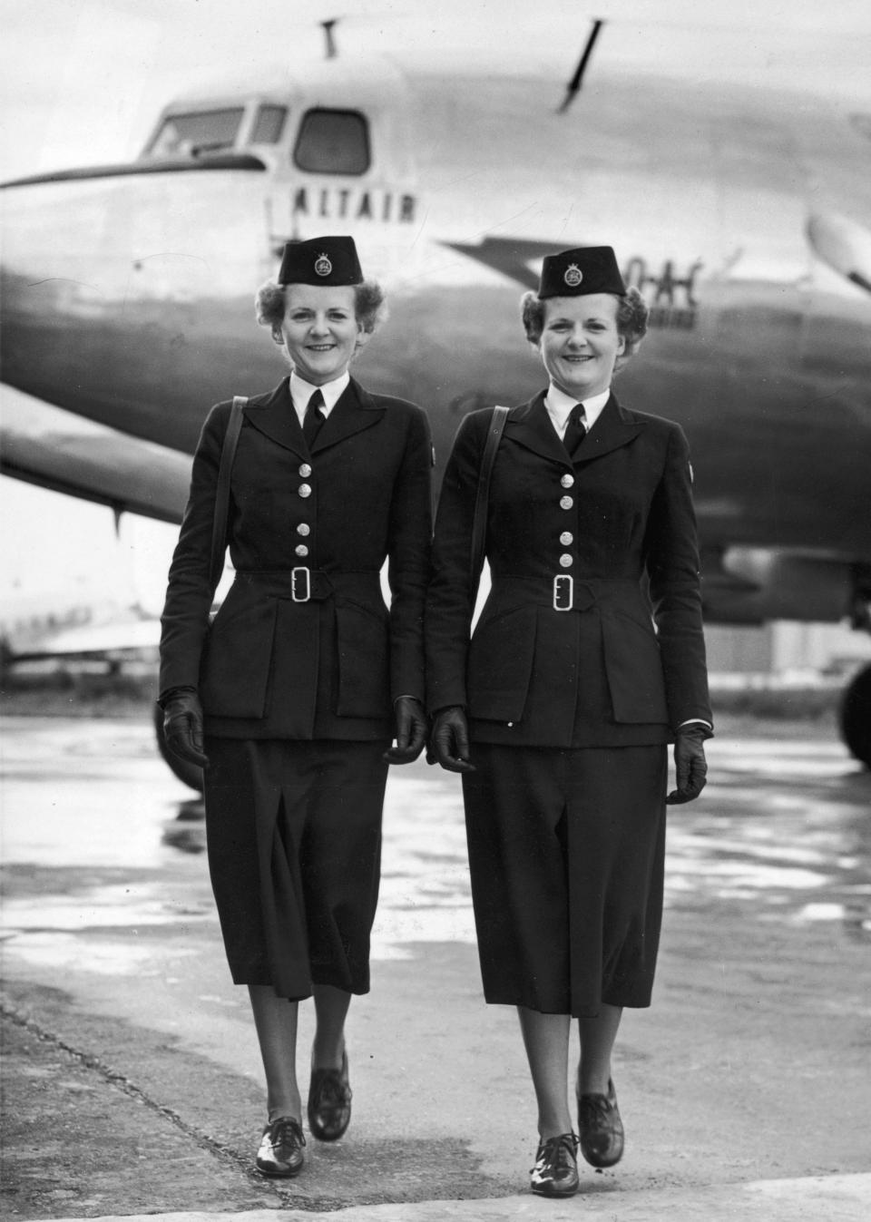 Twin sisters Barbara and Sheila Gordon wearing their flight attendant uniforms in England, circa 1945.