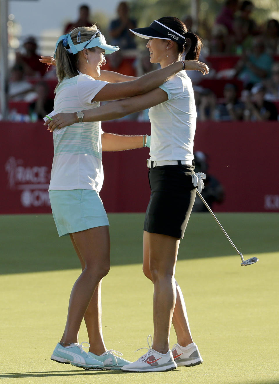 Lexi Thompson, left, hugs Michelle Wie after Thompson's three-stroke victory over Wie in the Kraft Nabisco Championship golf tournament Sunday, April 6, 2014, in Rancho Mirage, Calif. (AP Photo/Chris Carlson)