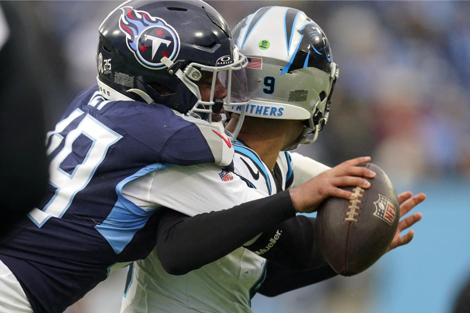 Tennessee Titans linebacker Arden Key (49) hits Carolina Panthers quarterback Bryce Young (9) and causes a fumble recovered by the Titans during the first half of an NFL football game Sunday, Nov. 26, 2023, in Nashville, Tenn. (AP Photo/George Walker IV)