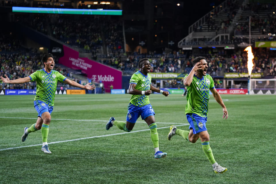 Seattle Sounders midfielder Cristian Roldan, right, celebrates his goal against the LA Galaxy with Josh Atencio, left, and Nouhou Tolo late in the second half of an MLS soccer match Wednesday, Oct. 4, 2023, in Seattle. AP Photo/Lindsey Wasson)